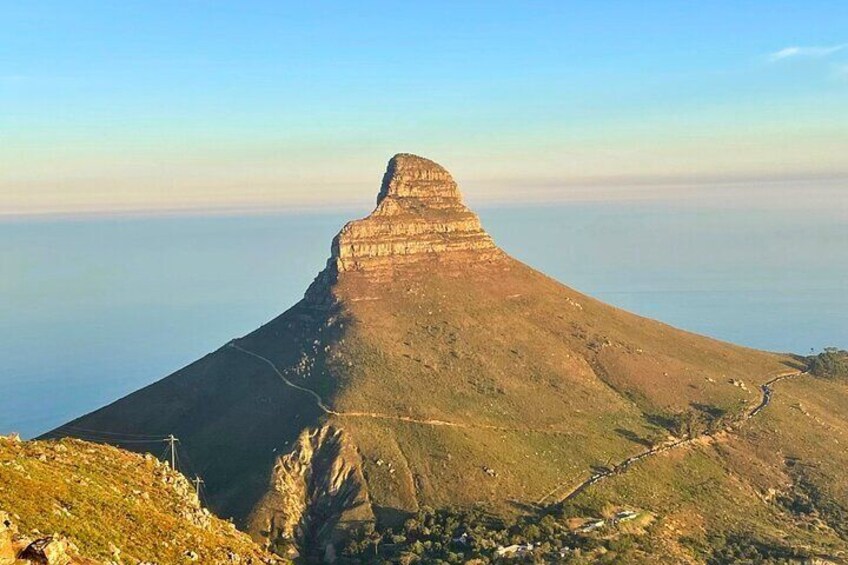 Lions Heads. This iconic peak offers a circular moderate rugged hiking trail route up toward the summit with stunning views across the city, its sunsets, sunrises, and Table Mountain