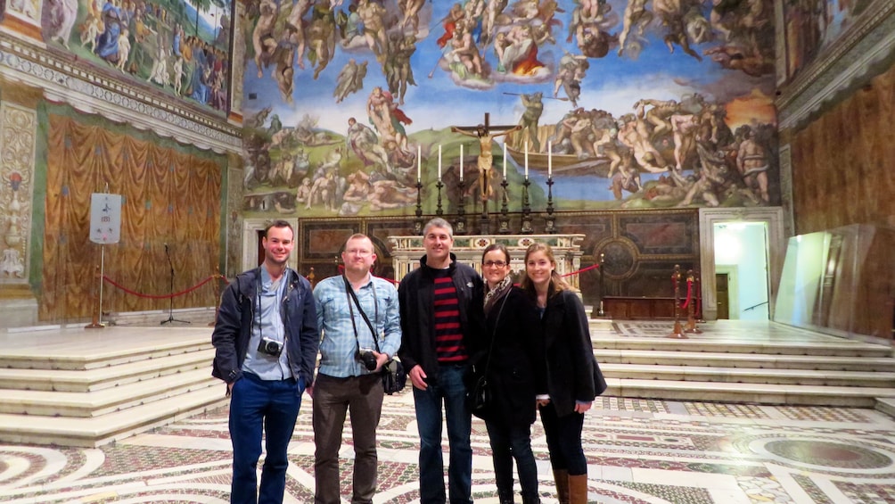 Tour group poses for photo in the vatican in Rome