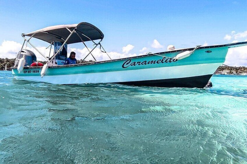 Our boat at the swimming stop in the middle of the sea of 7 colors, a shallow place