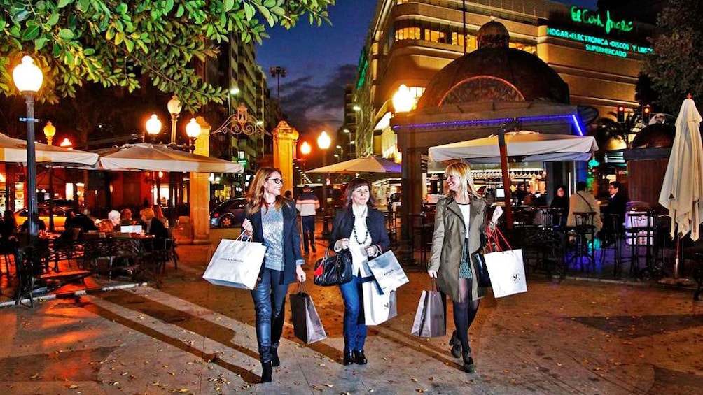 Show item 4 of 5. Shoppers in Alicante at night