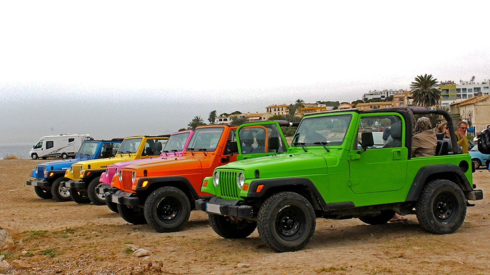 Show item 2 of 5. Colorful Jeeps parked on a beach in Costa Blanca