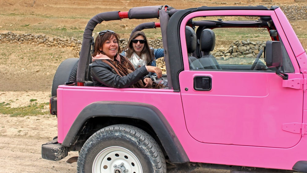 People in the back of a pink Jeep in Costa Blanca