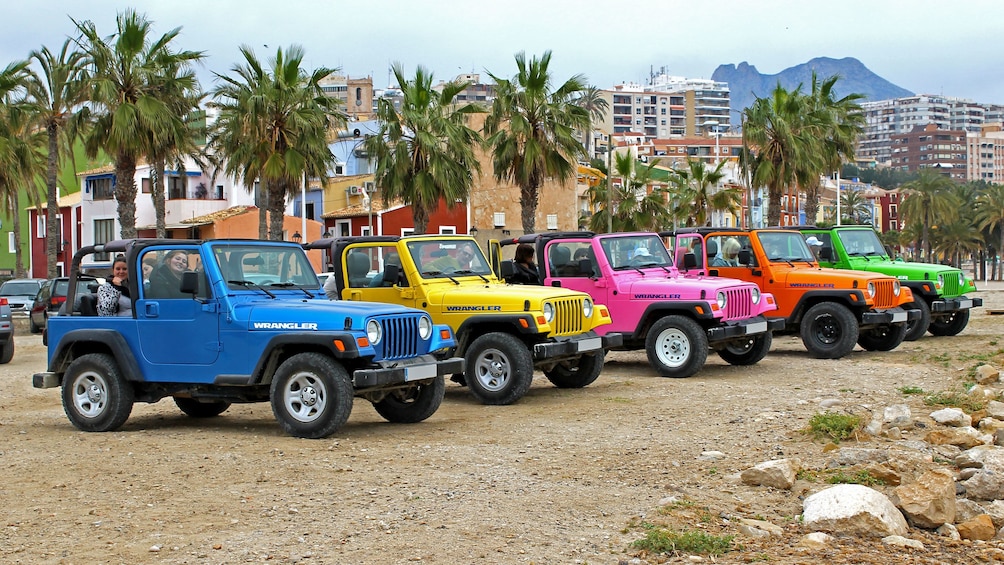 Show item 1 of 5. A Colorful assortment of jeeps parked in Costa Blanca
