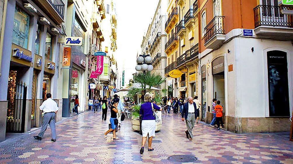 Show item 4 of 5. Storefronts on a bustling street in Valencia