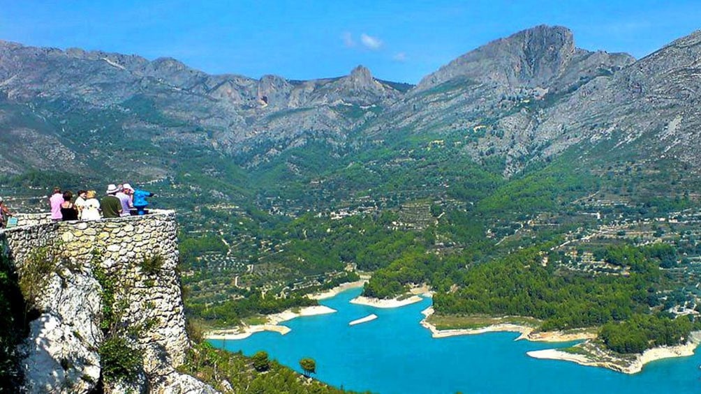 Show item 3 of 5. People looking out at the coast in Guadalest