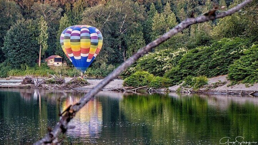 Floating just above the river in a hot air balloon