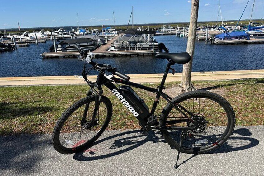 Electric mountain bike parked in front of the St. Cloud boat marina.