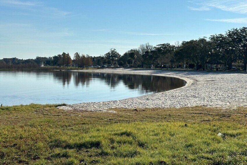 A side view of the sandy beach at St. Cloud Lakefront Park.