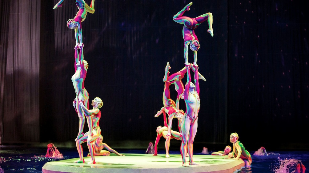 Performers climbing and balancing on one another in Cirque du Soleil O at the Bellagio in Las Vegas