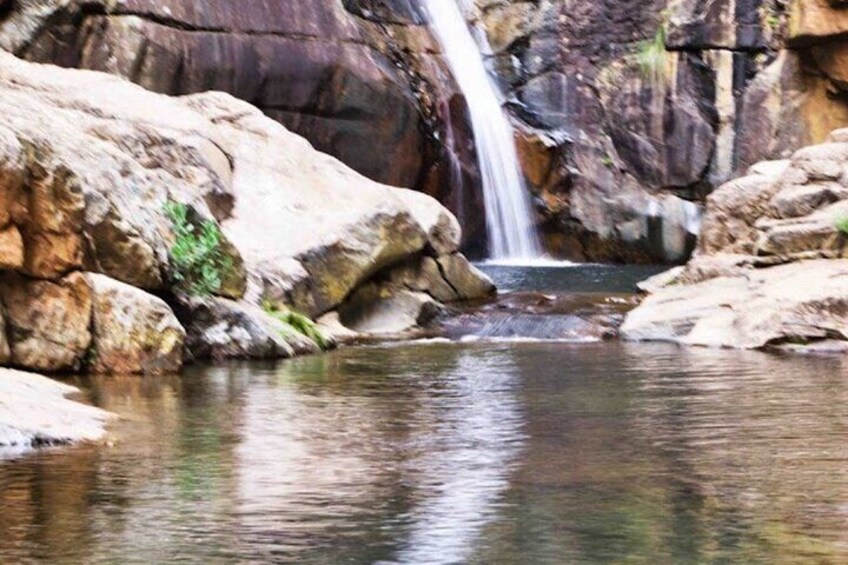 Swim under a waterfall.