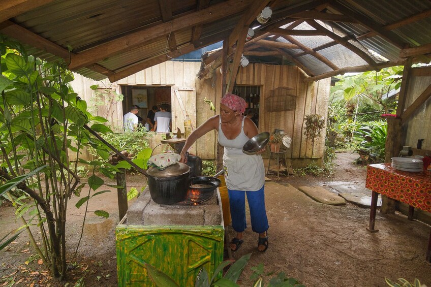 Woman cooking outside at Campesino Farm in Costa Rica