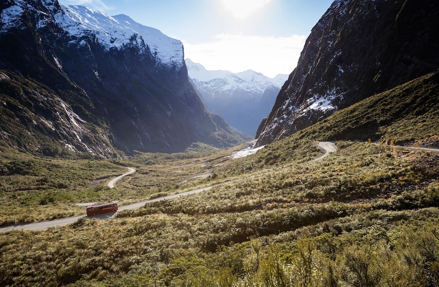 Bus on a winding road through the mountains in New Zealand