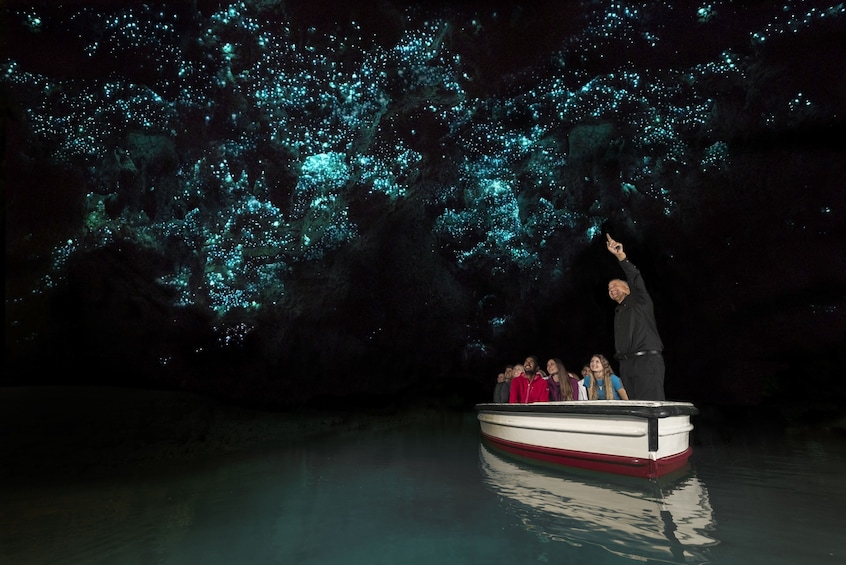 People in Waitomo glowworm cave in New Zealand