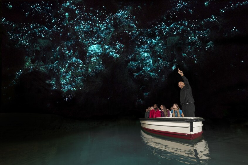 Show item 3 of 4. People in Waitomo glowworm cave in New Zealand