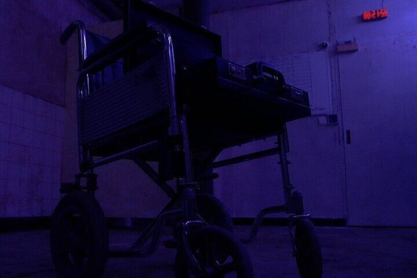 Creepy wheelchair in the SAWtopsy escape room at moviESCAPE Stockport