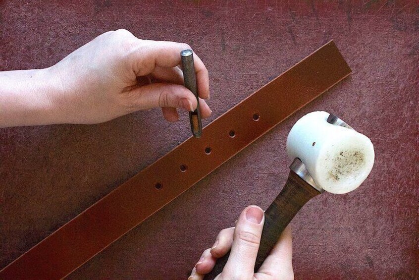 Step in manufacturing a high-end leather belt: Hammering