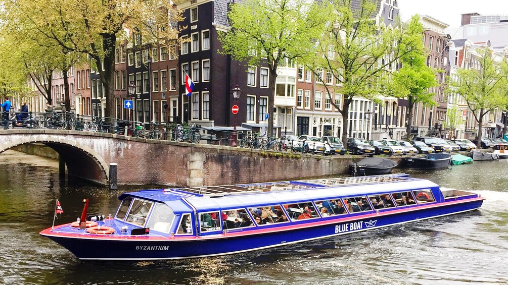 Tour boat traveling down canal in Amsterdam