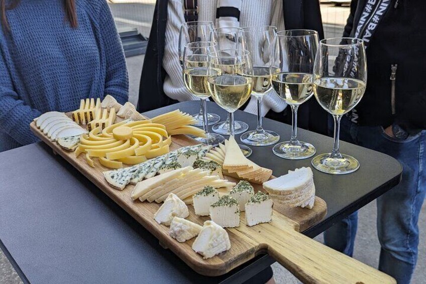 Assortment of regional cheeses with glass of white wine