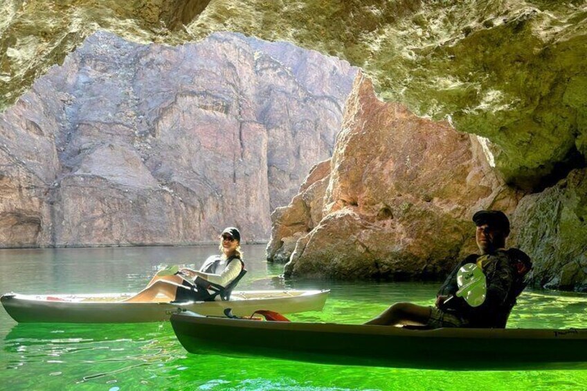 Kayakers pause to smile for the camera inside the Emerald Cave.