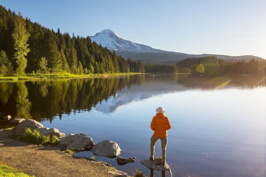 Man overlooking Trillium Lake and Mount Hood in background
