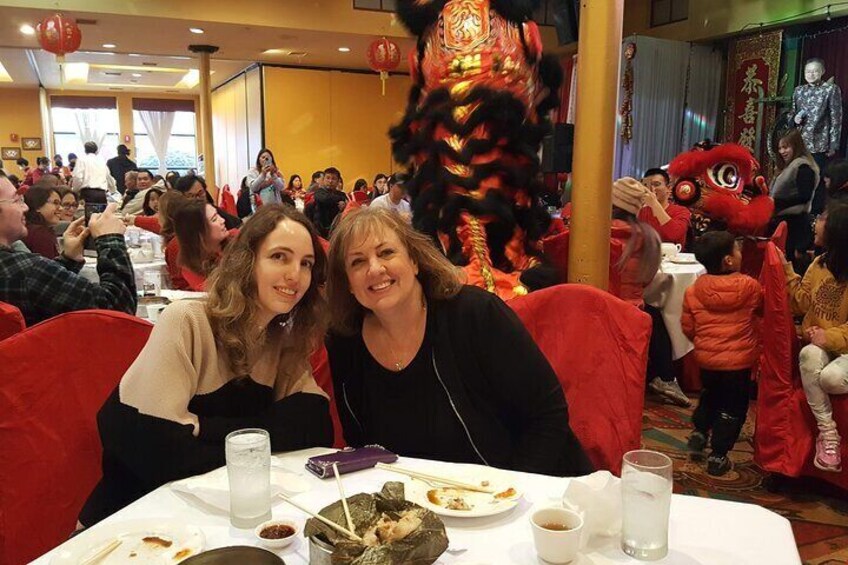 Celebrating Chinese New Year with lion dancers in the background.