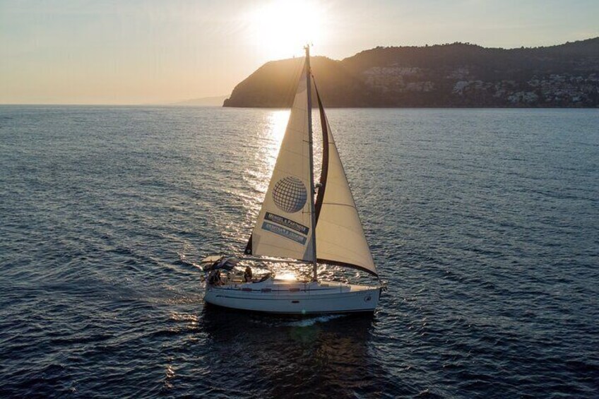 Sailing at sunset along the cliffs of Maro-Compartida