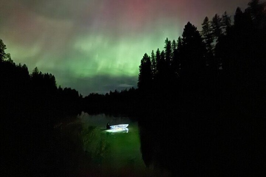 Watching the beautiful northern lights while paddling in a clear kayak