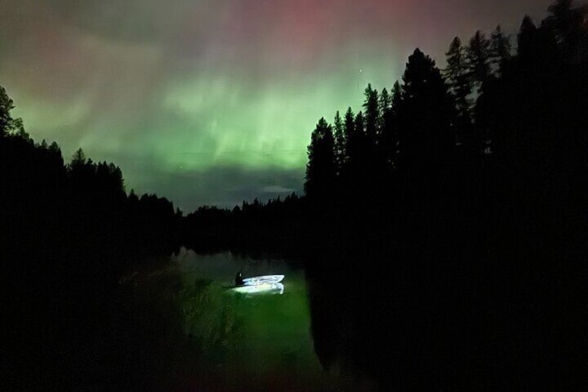 Watching the beautiful northern lights while paddling in a clear kayak