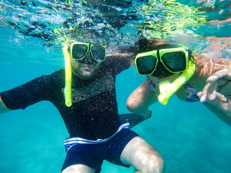 Underwater photo of snorkeling couple looking at camera