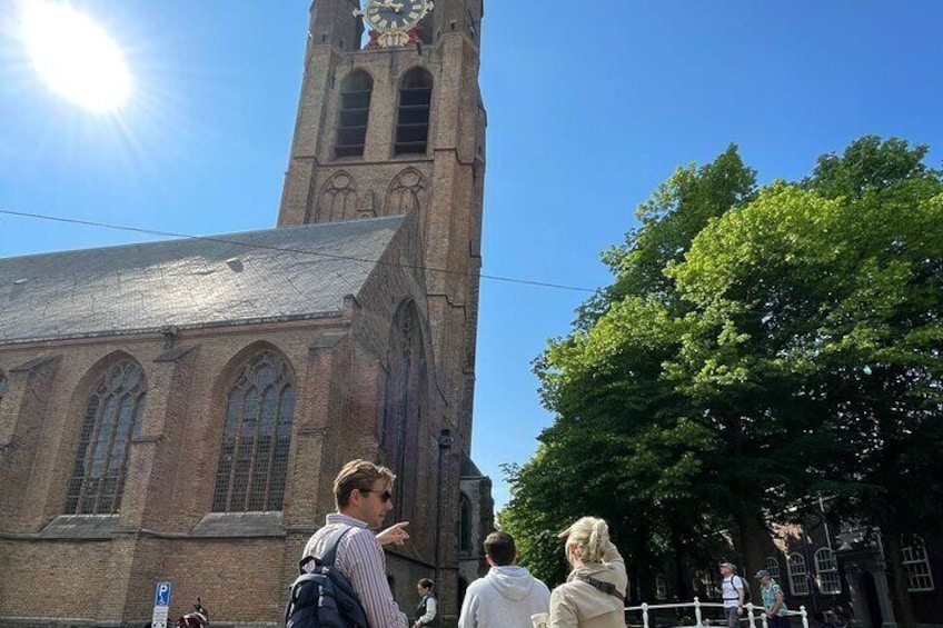 Guide and group in front of Old Church. Delft