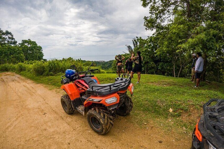 Guided ATV Tour on Mountain Dirt Road with Views of Roatan