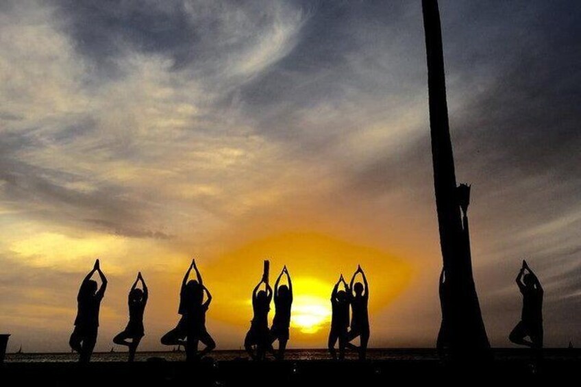 the best sunset views in waikiki are at our beach yoga spot