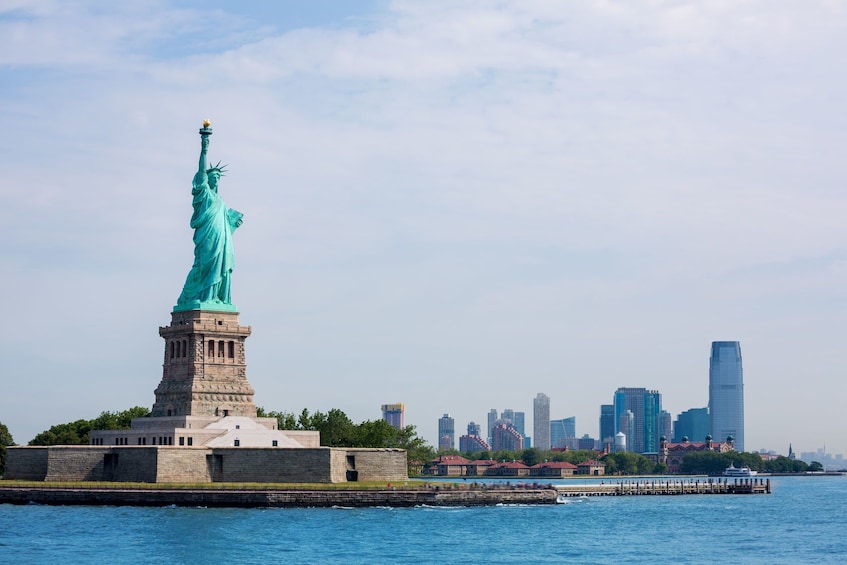 Wide shot of the Statue of Liberty with Manhattan in background