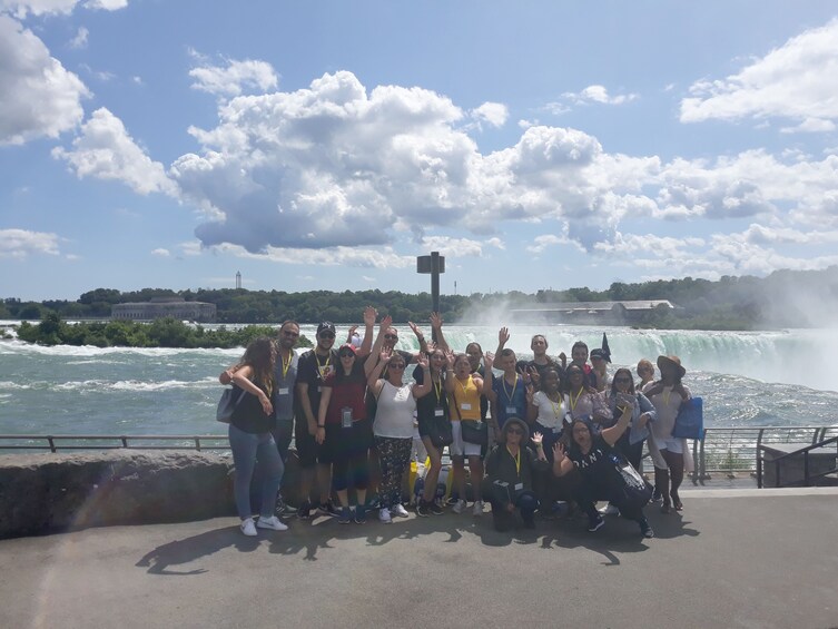 Tour group waving with Niagara Falls in background