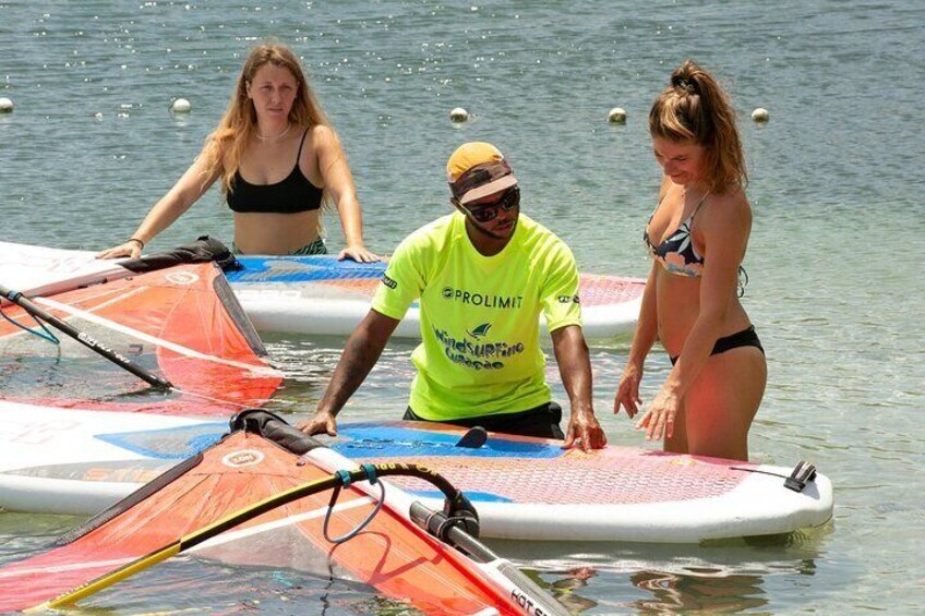 Our expert instructor provides in-water guidance to two eager students, ensuring a safe and fun learning experience.