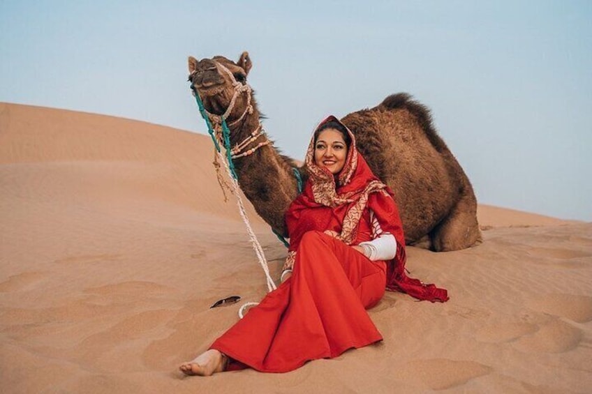 Healthy friendly camel with lovely guest.