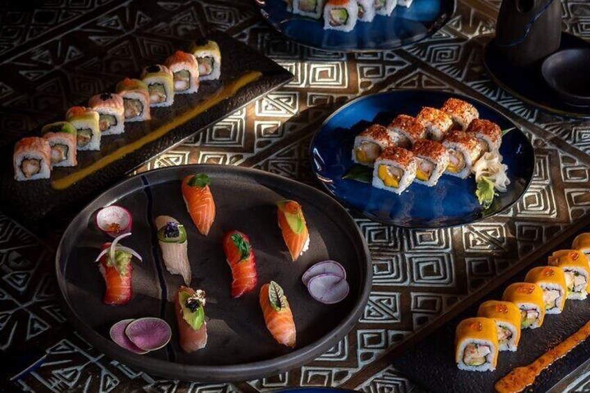 Different kinds of sushi rolls and sashimis ready for your indulgence.