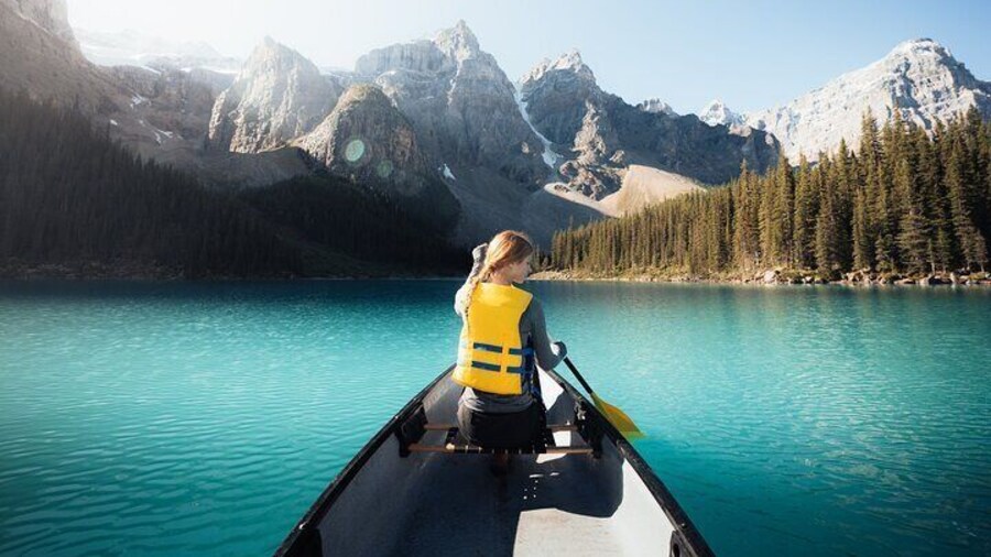 Explore the turquoise water of Moraine Lake in a canoe.