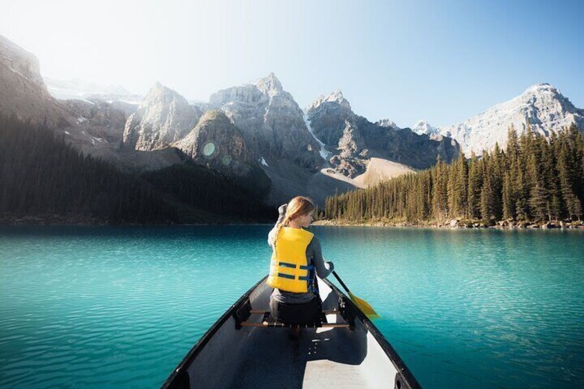 Explore the turquoise water of Moraine Lake in a canoe.