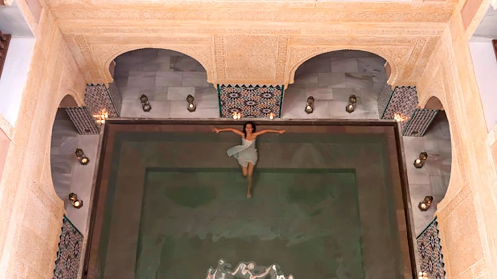 A woman soaks in the People soak in the Hammam Al Andalus bathhouse