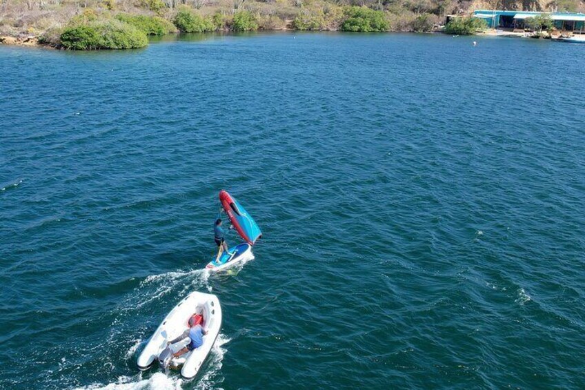 Personalized instruction with boat assistance ensures a smooth and safe learning experience for our wingfoil students on the calm Spanish Waters.