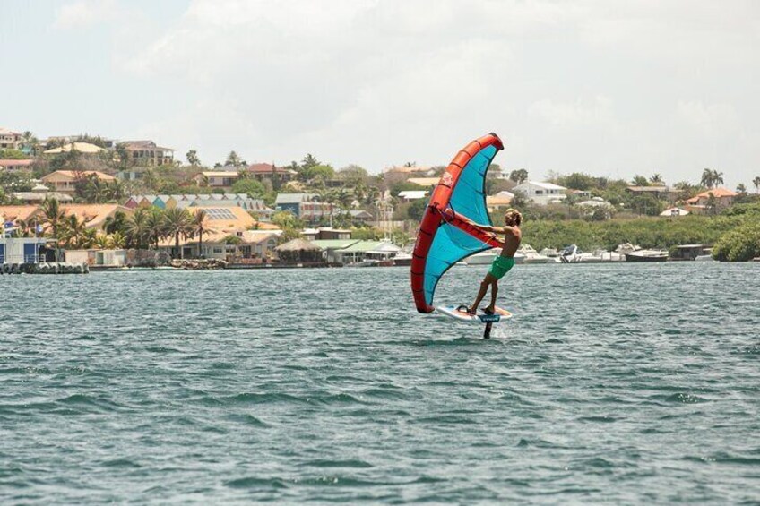 Experience the thrill of flying over the flat, serene waters of Spanish Waters with our expert wingfoil instruction.