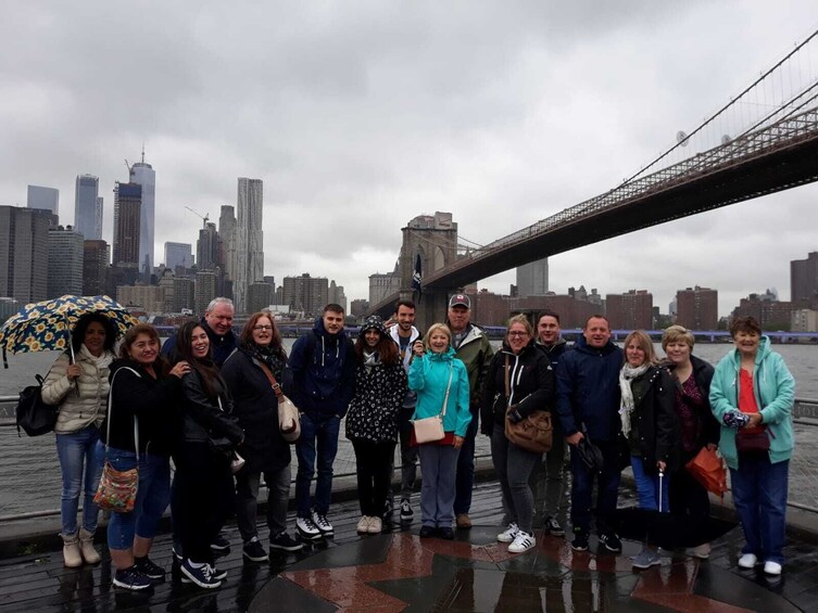 Tour group waves with Brooklyn Bridge in background