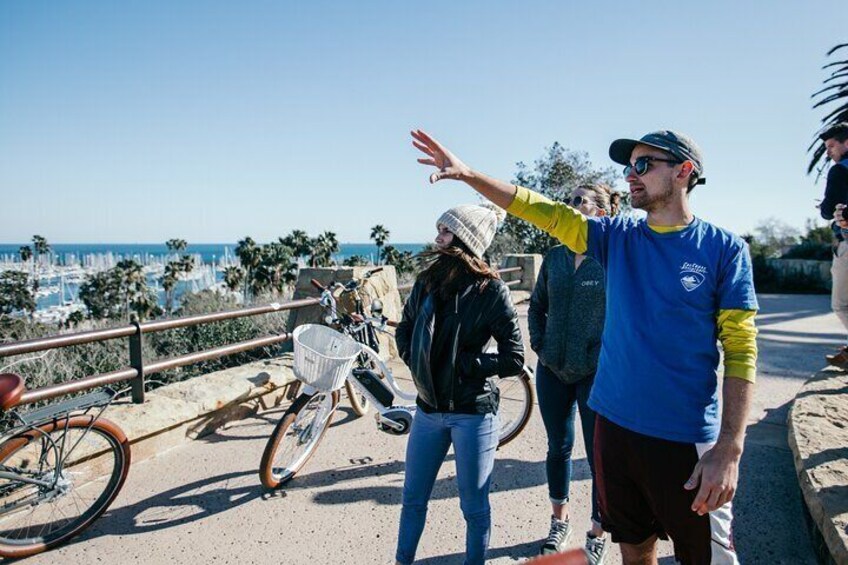 Tour guide explaining what the tour is seeing from a beautiful lookout.