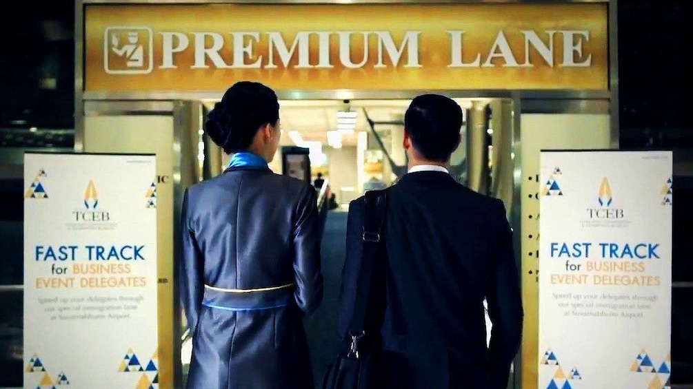 Two people in a Premium lane in an airport