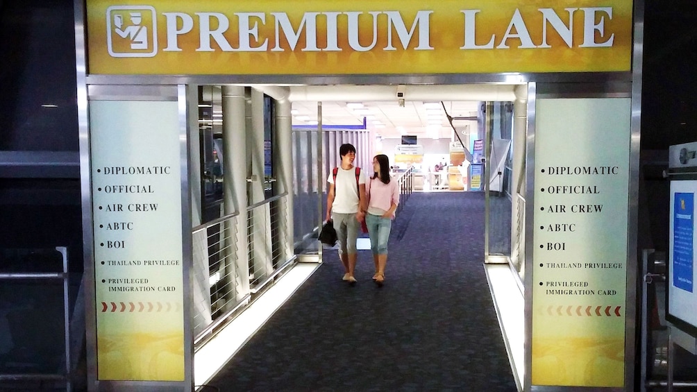 Couple walking through Premium Lane service