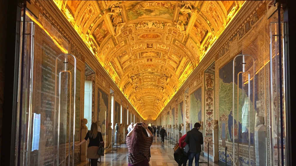 People viewing hallway at the Vatican in Rome