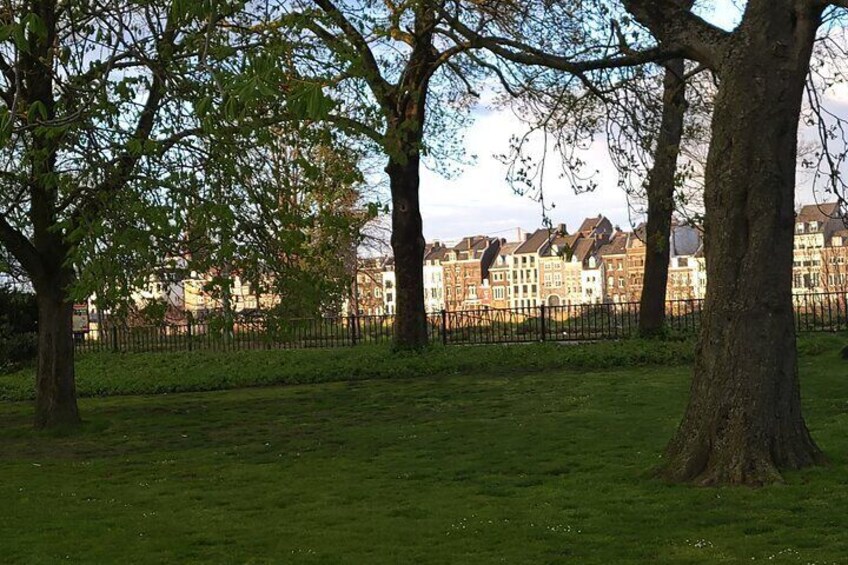 A beautiful day in the city park with a view of the historic Wyck on the other side of the river Maas