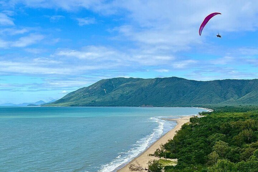 Fly along the tropical coastline between Cairns and Port Douglas.
