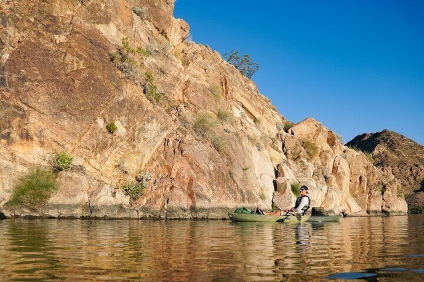 A paddler stops to view ancient petroglyphs. 